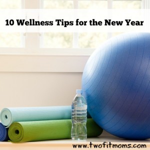 Balance ball, exercise mats and bottled water at gym by window.